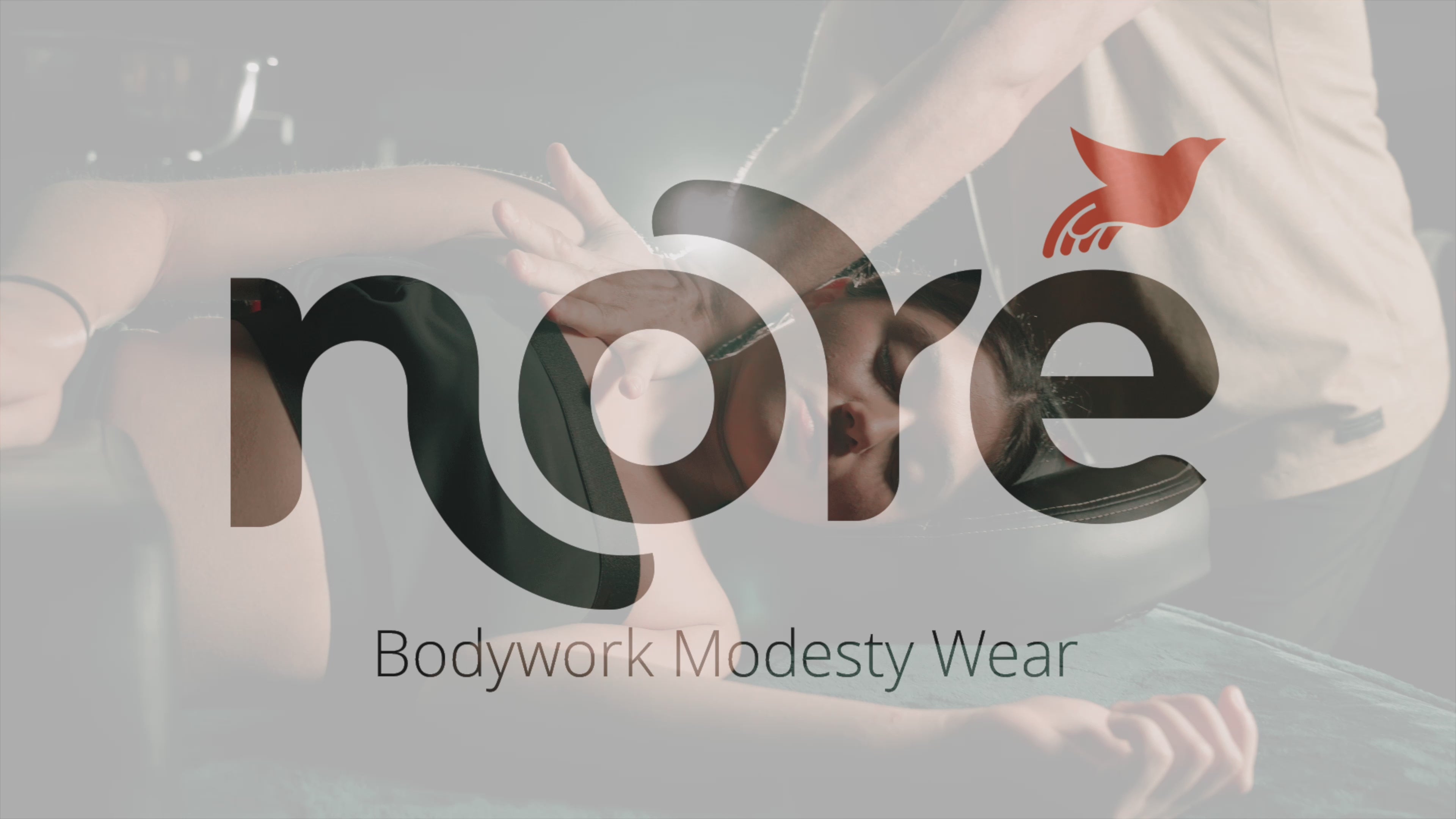 Load video: Therapist performing a massage while client wears Noré bodywork modesty top